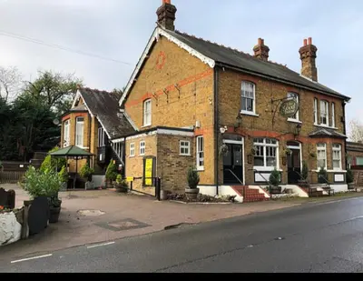 a large brick building on the side of a street at Good Intent Rooms in Waltham Abbey
