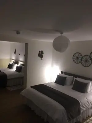 a bedroom with two beds in a room with bikes on the wall at Good Intent Rooms in Waltham Abbey