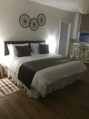 a bedroom with a large bed with two bicycles on the wall at Good Intent Rooms in Waltham Abbey