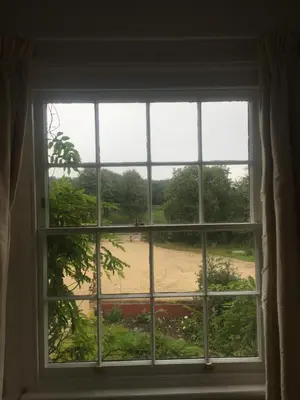 an open window with a view of a field at Waldegrave farm in Hartest