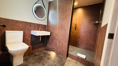 a bathroom with a toilet and a sink at The Suffolk Hotel in Haverhill