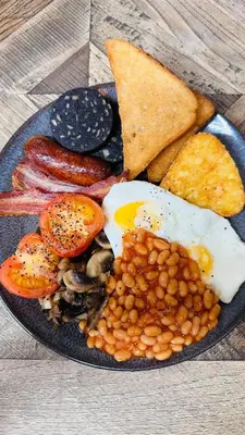 a plate of breakfast food with eggs beans and toast at The Suffolk Hotel in Haverhill