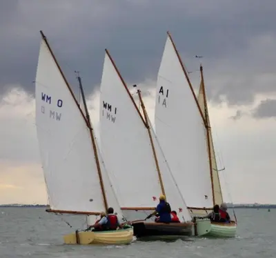 a group of three sailboats in the water at The retreat in West Mersea