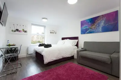 a bedroom with a bed and a couch at The Orlando in Cambridge