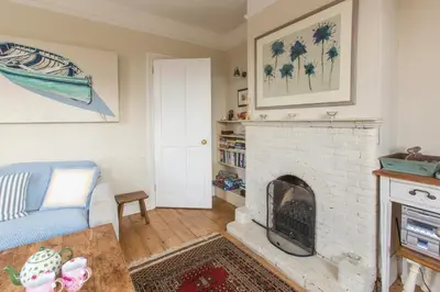 a living room with a white brick fireplace at Lower Saltings in Aldeburgh