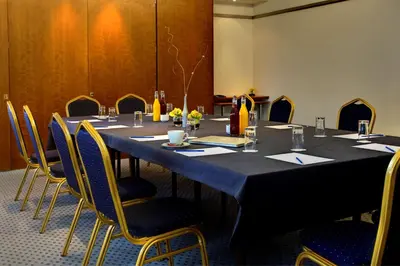 a conference room with a long table and chairs at Best Western Ipswich Hotel in Ipswich
