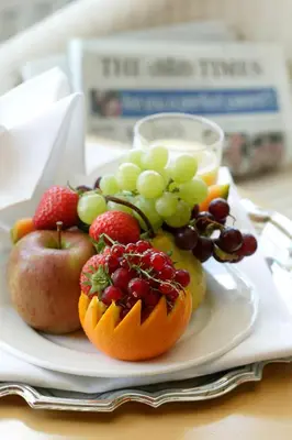 a plate with fruit and a pumpkin on a table at Best Western Ipswich Hotel in Ipswich