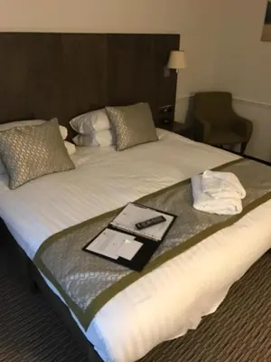 a bed in a hotel room with a tray on it at Best Western Ipswich Hotel in Ipswich