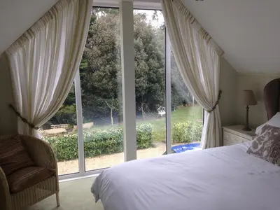 a bedroom with a bed and a large window at Squirrel in Southwold