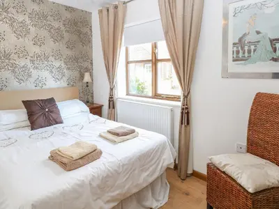 a bedroom with a bed with two towels on it at The Haybarn in West Bradenham