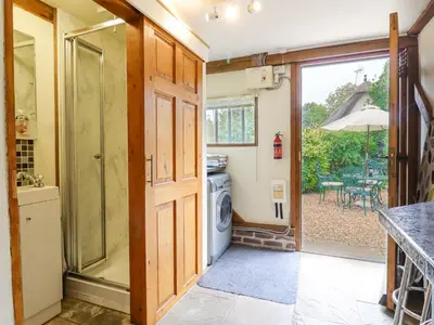 a laundry room with a washer and dryer in a house at The Studio, Horseshoe Cottage in Fulbourn