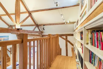 a hallway in a house with wooden beams at Ducksfoot Barn in Pulham Saint Mary Magdalene