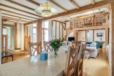 a dining room with a table and chairs at Ducksfoot Barn in Pulham Saint Mary Magdalene