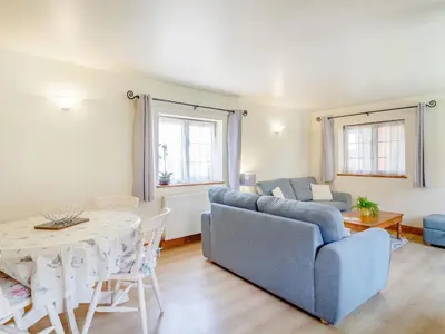 a living room with a couch and a table at Horseshoe in Little Glenham