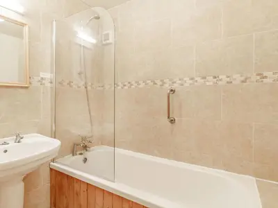 a bathroom with a sink and a tub and a toilet at Horseshoe in Little Glenham