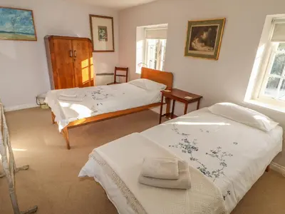 a bedroom with two beds and a window at 28 Oxborough in Oxborough