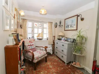 a living room with a chair and a dresser at Peggotty's in Kelsale