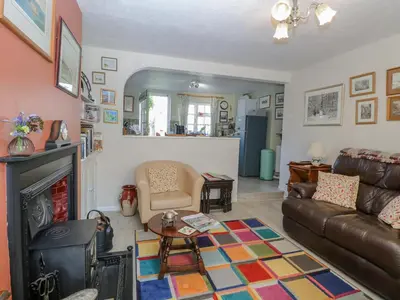 a living room with a couch and a fireplace at Peggotty's in Kelsale
