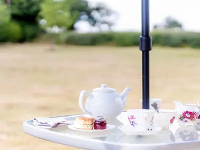 a tea set on a tray with a tea pot and cups at Norbank Garden Studio in Bressingham
