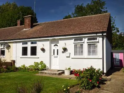 a white house with a brown roof at Spurling Cottage in Cheveley