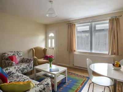 a living room with a couch and a table at Spurling Cottage in Cheveley