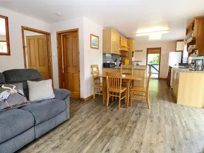 a living room with a couch and a table at Dragonfly Lodge in Yaxham