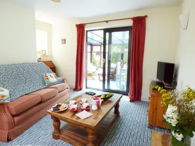 a living room with a couch and a coffee table at 27 Swan Street in Boxford