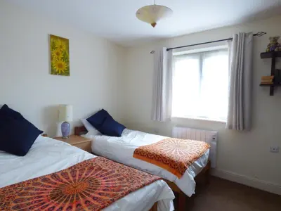 a bedroom with two beds and a window at 27 Swan Street in Boxford