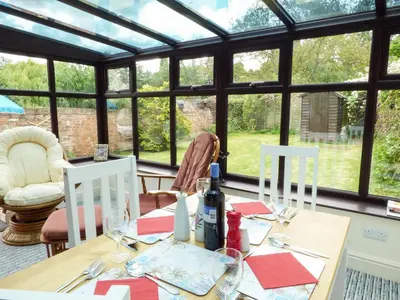 a dining room with a table with red napkins at 27 Swan Street in Boxford