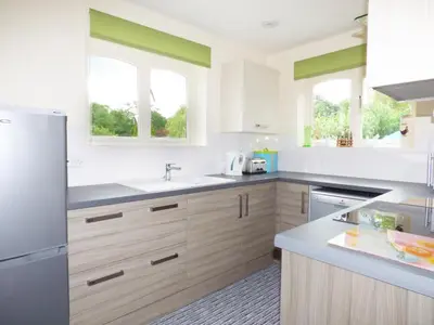 a kitchen with white appliances and two windows at 27 Swan Street in Boxford