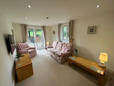 a living room with two chairs and a coffee table at Meadows Barn in Chelmsford