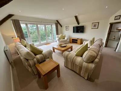 a large living room with couches and a tv at Meadows Barn in Chelmsford
