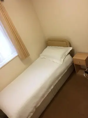 a small bed in a small room with a window at The Black Bull Inn in Fyfield