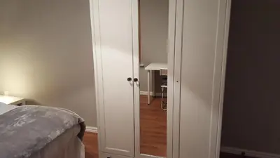 a bedroom with a door leading into a room with a bed at Haus Serviced Living in Braintree