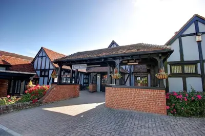 a building with a brick courtyard with flowers at The New Chichester Hotel in Wickford