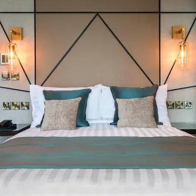 a bedroom with a large bed with two pillows at Seven Hotel in Southend-on-Sea