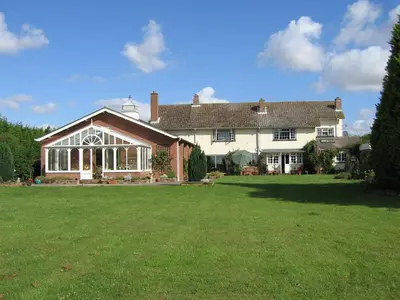 a large house with a large lawn in front of it at Newmans Hall Bed & Breakfast in Little Waldingfield