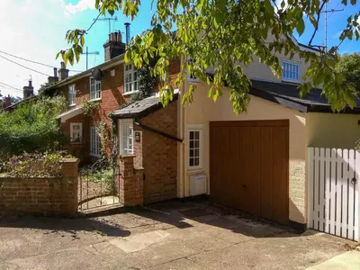 a brick house with a garage in front of it at Jasmine Cottage, Kelsale, sleeps 5 - Aldeburgh Coastal Cottages in Kelsale