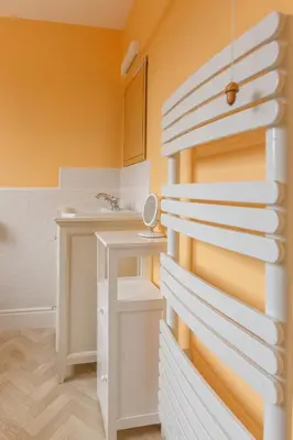 a bathroom with yellow walls and a white sink at Jasmine Cottage, Kelsale, sleeps 5 - Aldeburgh Coastal Cottages in Kelsale