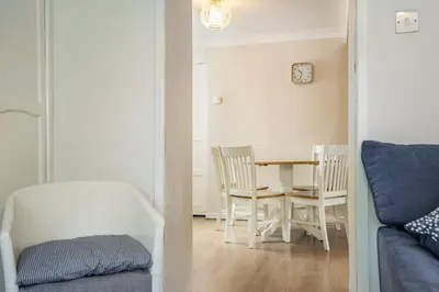 a room with a table and chairs and a dining room at Violet Cottage in Feltwell