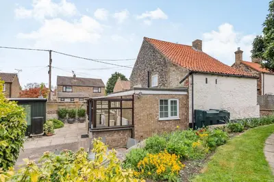 an extension to a house with a garden at Violet Cottage in Feltwell