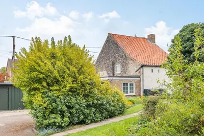 a brick house with a red roof at Violet Cottage in Feltwell