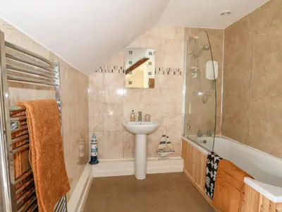 a bathroom with a sink and a shower and a sink at Manor Farm Cottage in Swaffham