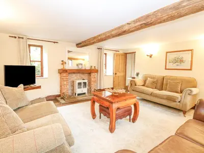 a living room with a couch and a table at The Hayloft in Ashill