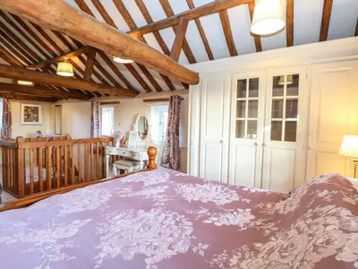 a bedroom with a large bed in a room at The Dairy in Ashill