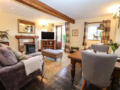a living room with a couch and a table at The Dairy in Ashill