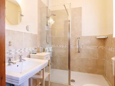 a bathroom with a shower and a sink at Barn Owl Cottage in Little Glenham