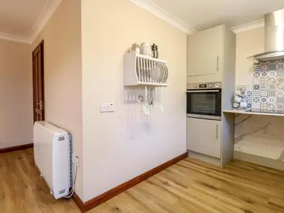 a kitchen with a white refrigerator and a counter at Kingfisher in Wattisfield