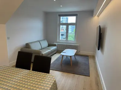 a living room with a couch and a table at Brentwood Hotel & Apartments in Brentwood