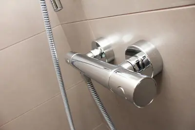 a metal door handle on a bathroom stall at Brentwood Hotel & Apartments in Brentwood